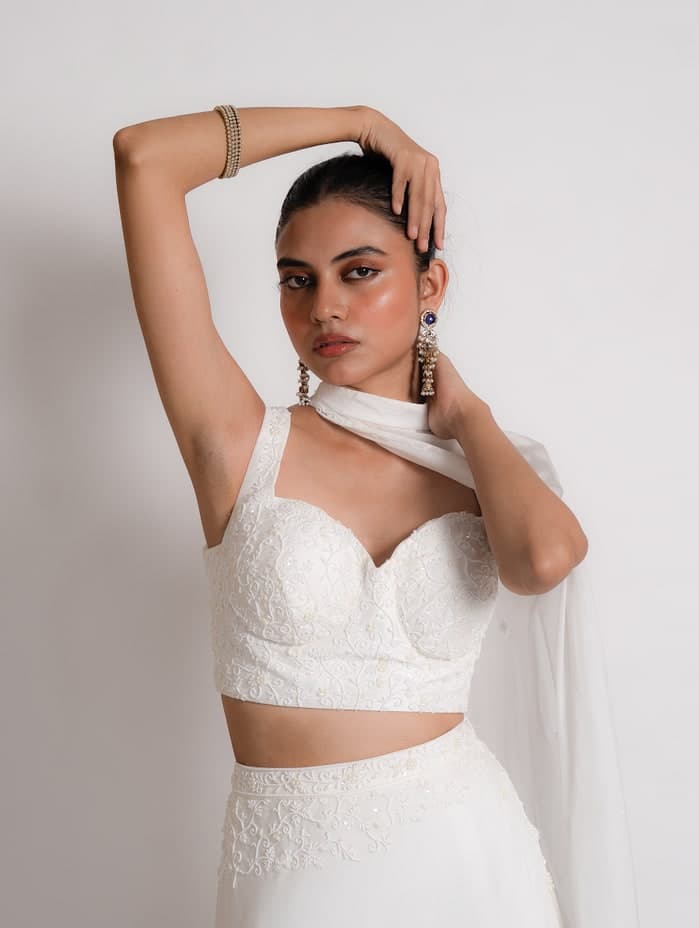 Noor set in ivory, portrait showing the bustier blouse and pearl work