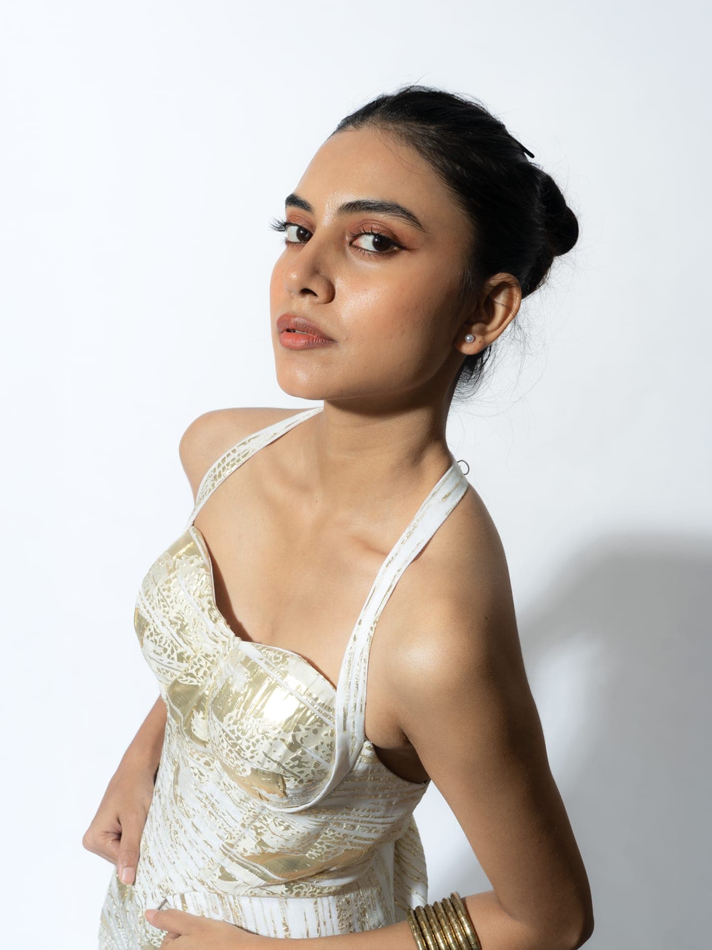 Amari peplum corset top in ivory and gold foil fabric, worn, portrait