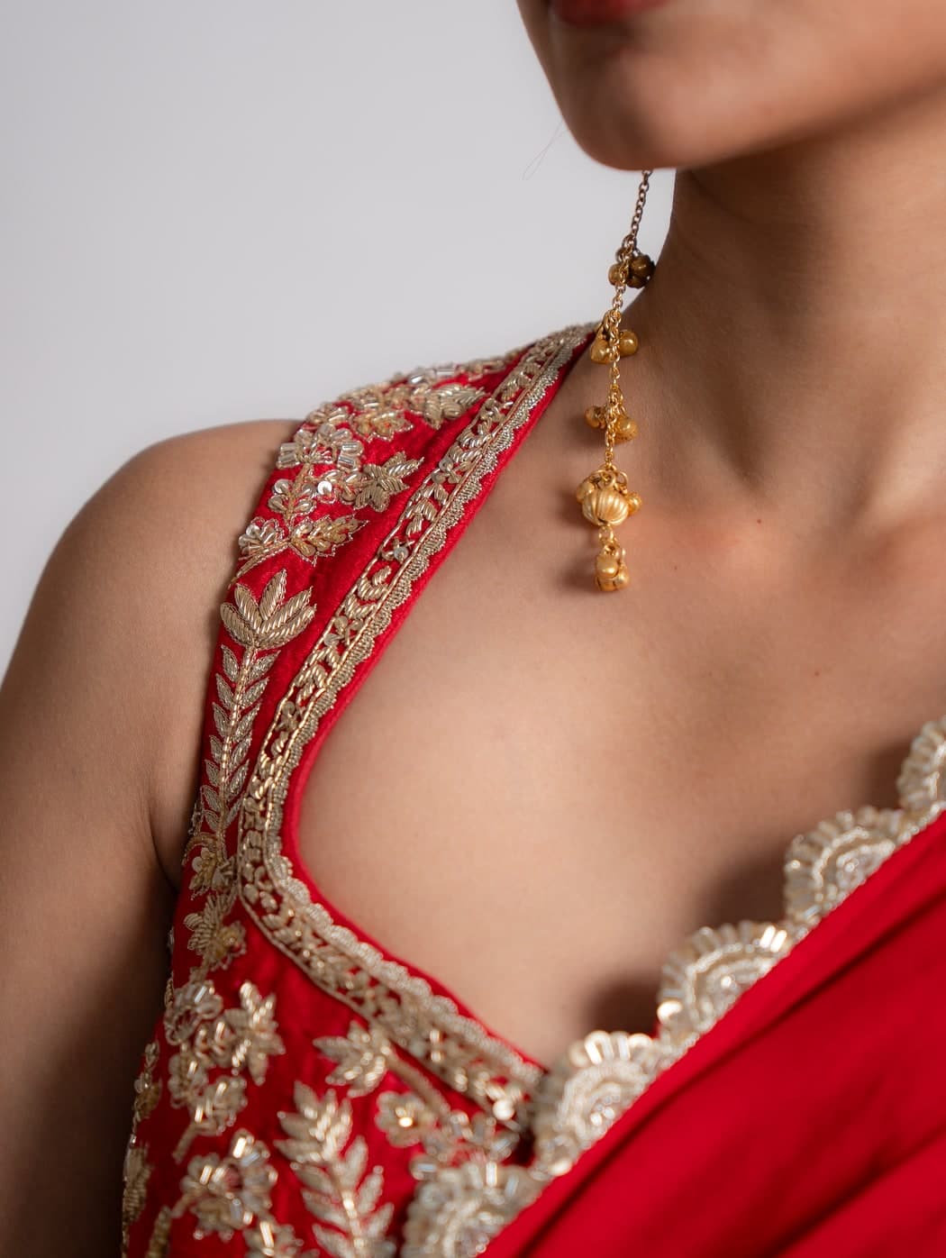 Nina saree in red, close view of the zardosi embroidered blouse and scallop border
