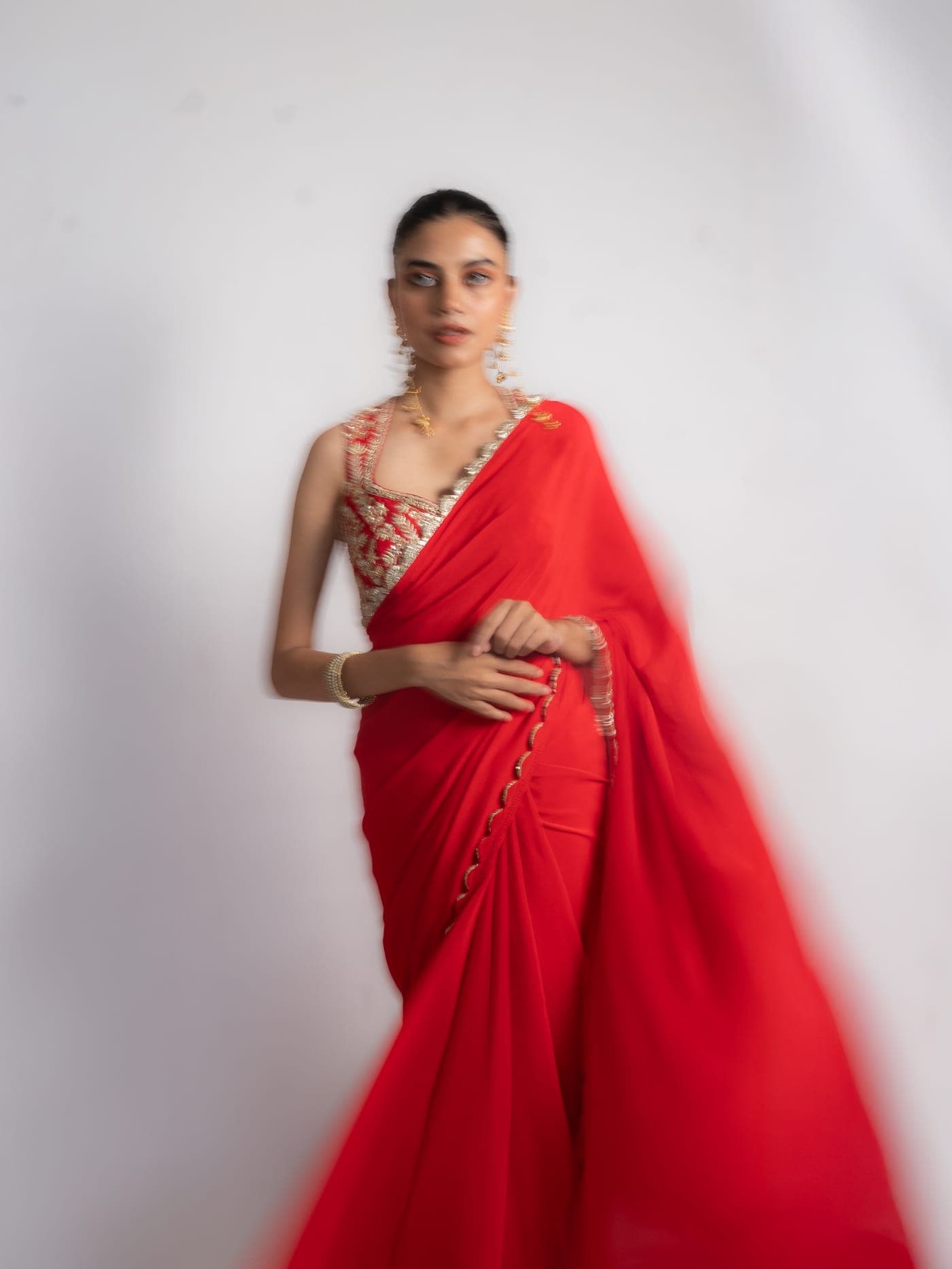 Nina silk crepe saree in red, full drape caught in movement